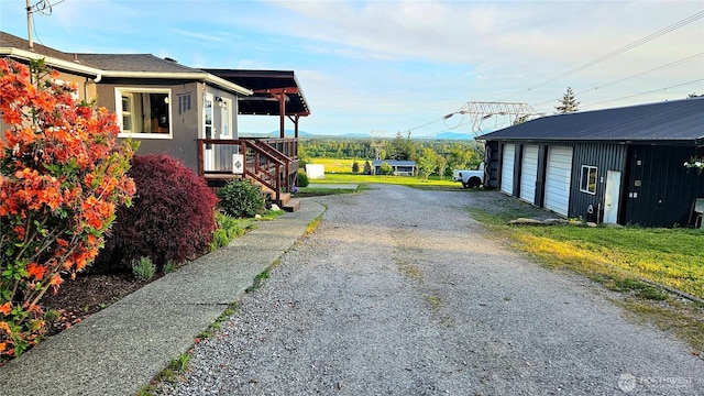 4319 H Street Rd, Blaine, WA 98230 - view of side of property with a garage, stucco siding, and an outbuilding