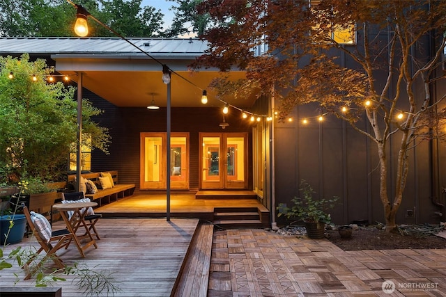 10608 NE 157th St, Bothell, WA 98011 - back of house with board and batten siding, french doors, a wooden deck, and metal roof