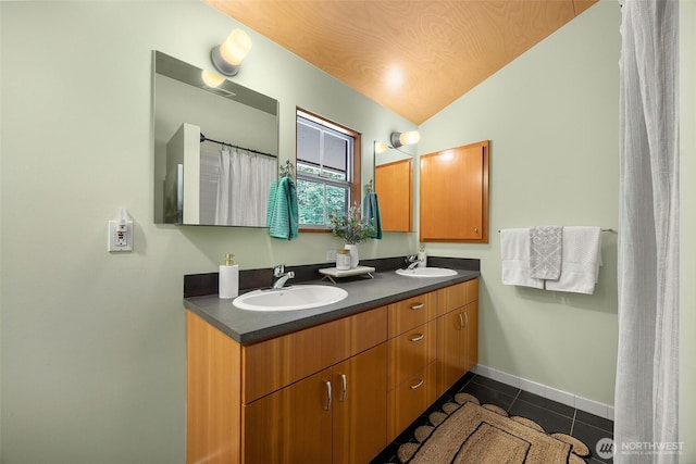 10608 NE 157th St, Bothell, WA 98011 - bathroom with vaulted ceiling, double vanity, tile patterned flooring, and baseboards