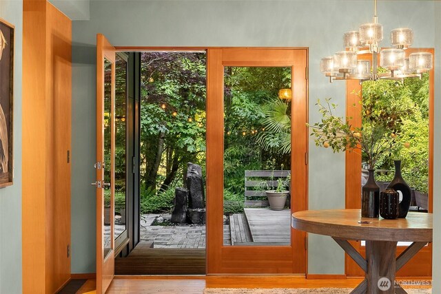 10608 NE 157th St, Bothell, WA 98011 - doorway with a chandelier and wood finished floors