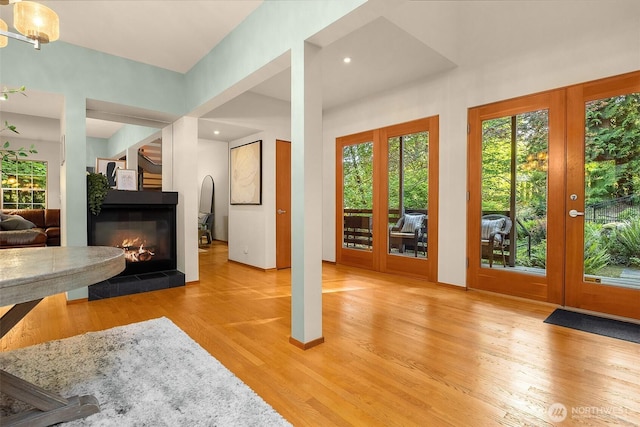 10608 NE 157th St, Bothell, WA 98011 - living room with light wood-type flooring and a multi sided fireplace