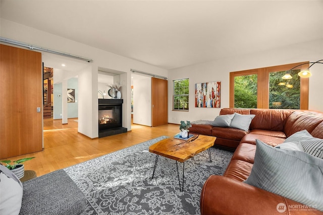 10608 NE 157th St, Bothell, WA 98011 - living area featuring wood finished floors and a multi sided fireplace