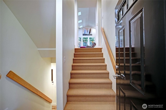 1577 Arrowhead Beach Rd, Camano Island, WA 98282 - stairway featuring lofted ceiling and baseboards