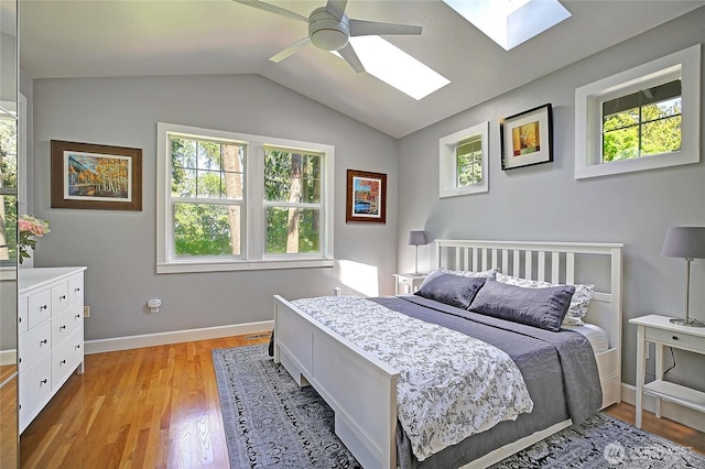 1577 Arrowhead Beach Rd, Camano Island, WA 98282 - bedroom featuring a skylight, multiple windows, light wood-style flooring, and vaulted ceiling