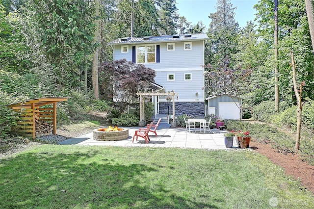 1577 Arrowhead Beach Rd, Camano Island, WA 98282 - back of house with an outdoor fire pit, a pergola, a patio area, a yard, and stone siding