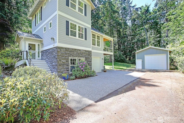 1577 Arrowhead Beach Rd, Camano Island, WA 98282 - view of side of property with driveway, stone siding, an outdoor structure, and a garage