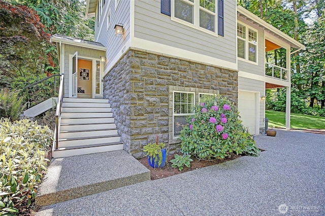 1577 Arrowhead Beach Rd, Camano Island, WA 98282 - doorway to property with stone siding and an attached garage