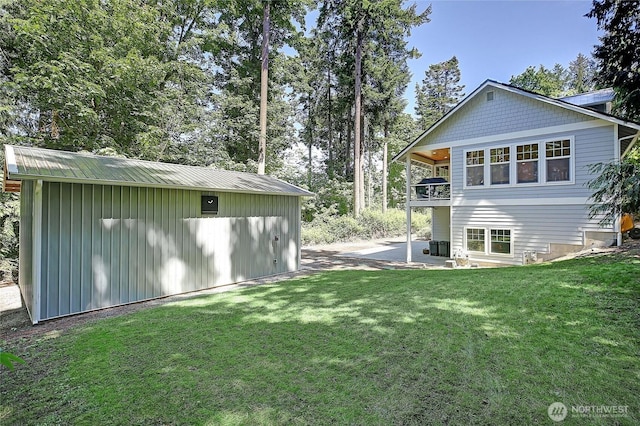 1577 Arrowhead Beach Rd, Camano Island, WA 98282 - back of property with a lawn, an outbuilding, a patio area, metal roof, and a balcony