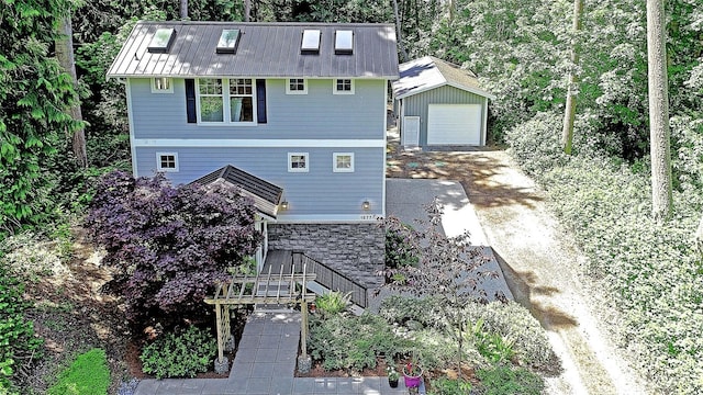 1577 Arrowhead Beach Rd, Camano Island, WA 98282 - view of front of home featuring an outbuilding, a detached garage, driveway, and metal roof