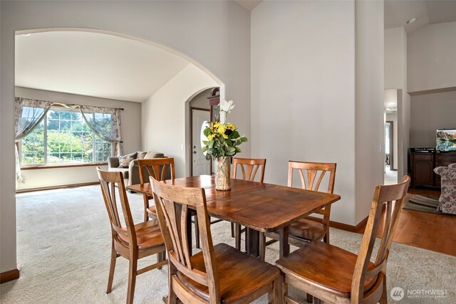 3210 275th St NE, Arlington, WA 98223 - dining room with carpet flooring, arched walkways, and high vaulted ceiling