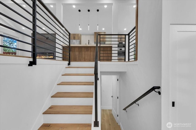 12816 130th Ct NE, Kirkland, WA 98034 - stairs with wood finished floors, baseboards, and a high ceiling