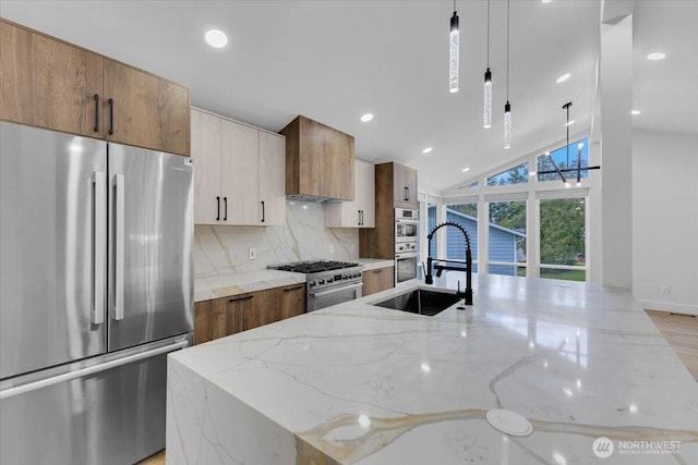 12816 130th Ct NE, Kirkland, WA 98034 - kitchen featuring stainless steel appliances, a sink, decorative backsplash, light stone counters, and a center island with sink