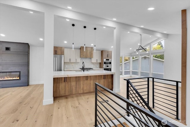12816 130th Ct NE, Kirkland, WA 98034 - kitchen with stainless steel appliances, light wood-style floors, light countertops, modern cabinets, and recessed lighting