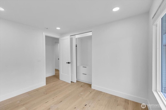 12816 130th Ct NE, Kirkland, WA 98034 - unfurnished bedroom featuring recessed lighting, baseboards, light wood-style flooring, and a closet