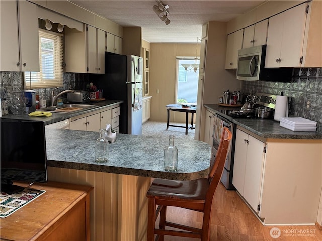 1415 84th St SE Unit 196, Everett, WA 98208 - kitchen featuring appliances with stainless steel finishes, dark countertops, and backsplash