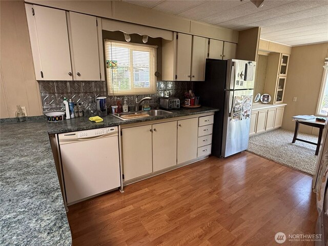 1415 84th St SE Unit 196, Everett, WA 98208 - kitchen featuring dishwasher, freestanding refrigerator, light wood-type flooring, and tasteful backsplash
