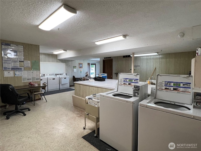1415 84th St SE Unit 196, Everett, WA 98208 - communal laundry room featuring washer and clothes dryer, wooden walls, light floors, and a textured ceiling