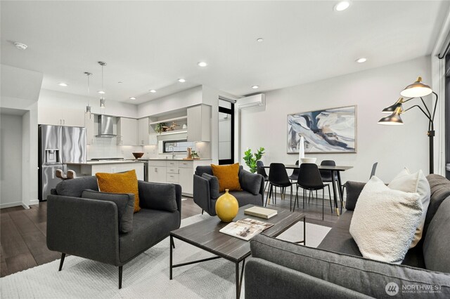 3219 California Ave SW Unit B, Seattle, WA 98116 - living area with wood finished floors, recessed lighting, an AC wall unit, and baseboards