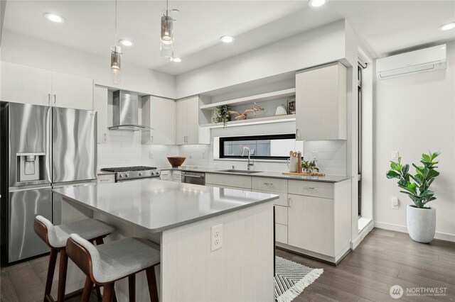 3219 California Ave SW Unit B, Seattle, WA 98116 - kitchen with appliances with stainless steel finishes, wall chimney range hood, an AC wall unit, open shelves, and a sink