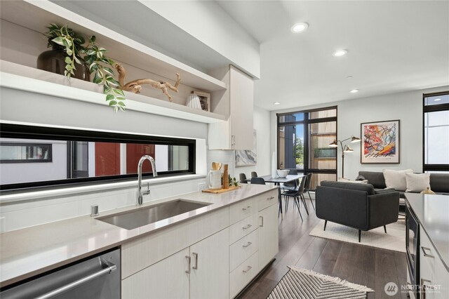 3219 California Ave SW Unit B, Seattle, WA 98116 - kitchen with a sink, stainless steel dishwasher, plenty of natural light, white cabinetry, and recessed lighting