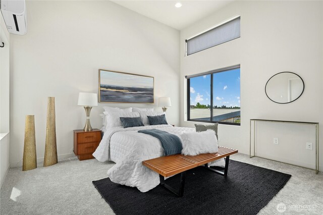 3219 California Ave SW Unit B, Seattle, WA 98116 - carpeted bedroom featuring an AC wall unit, a towering ceiling, baseboards, and recessed lighting