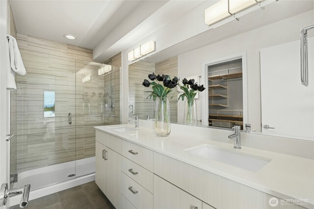 3219 California Ave SW Unit B, Seattle, WA 98116 - bathroom featuring double vanity, a stall shower, a walk in closet, recessed lighting, and tile patterned floors