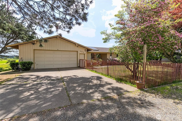 405 E Wiser Lake Rd, Lynden, WA 98264 - view of front of home with driveway, solar panels, a garage, and a fenced front yard