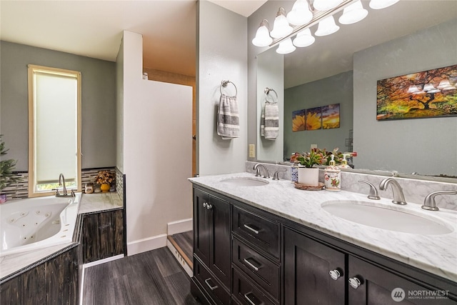 405 E Wiser Lake Rd, Lynden, WA 98264 - full bathroom featuring wood finished floors, double vanity, a whirlpool tub, and baseboards