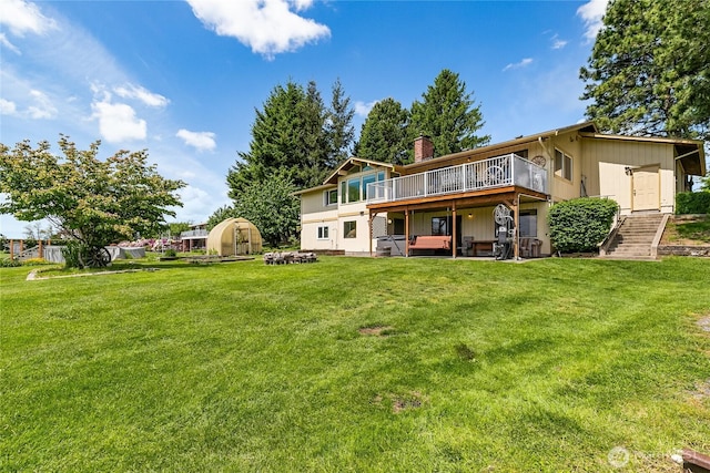 405 E Wiser Lake Rd, Lynden, WA 98264 - rear view of property with a chimney, a deck, and a lawn