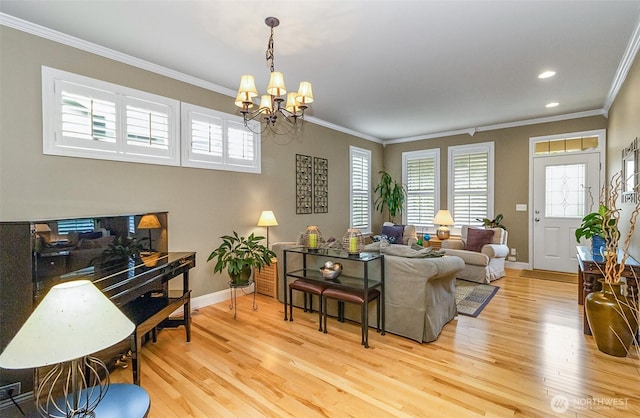 7623 152nd St SE, Snohomish, WA 98296 - living area featuring crown molding, light wood-style flooring, a chandelier, baseboards, and healthy amount of natural light