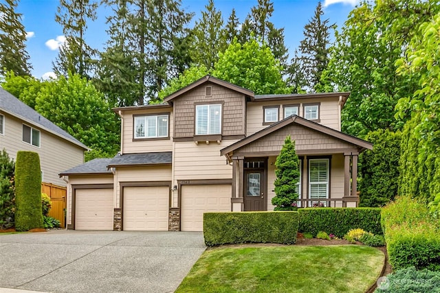 7623 152nd St SE, Snohomish, WA 98296 - view of front of home featuring concrete driveway, a garage, a porch, and stone siding