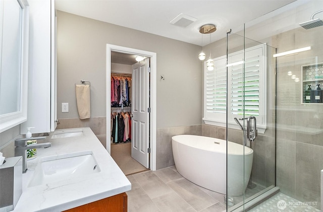 7623 152nd St SE, Snohomish, WA 98296 - full bath featuring double vanity, a shower stall, tile walls, a freestanding bath, and a spacious closet