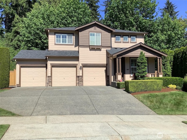 7623 152nd St SE, Snohomish, WA 98296 - view of front of home with an attached garage, driveway, a porch, and stone siding