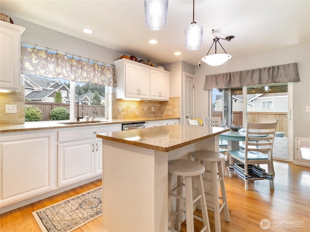 11920 184th St E, Puyallup, WA 98374 - kitchen with healthy amount of natural light, a sink, light stone counters, a kitchen island, and recessed lighting