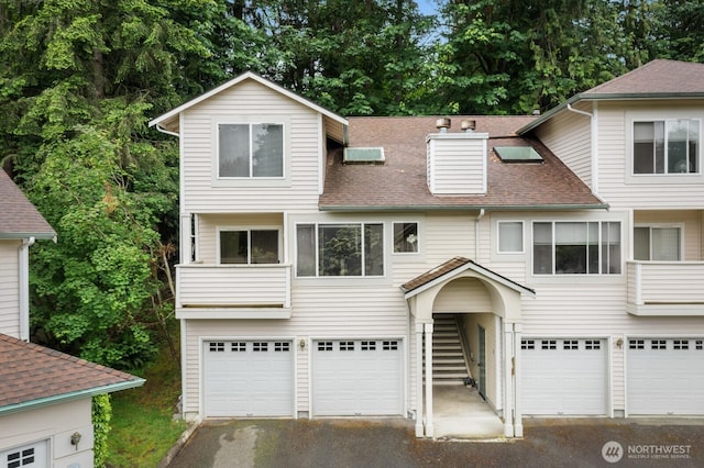 8828 238th St SW Unit D-1, Edmonds, WA 98026 - view of front facade featuring a garage, driveway, and a shingled roof