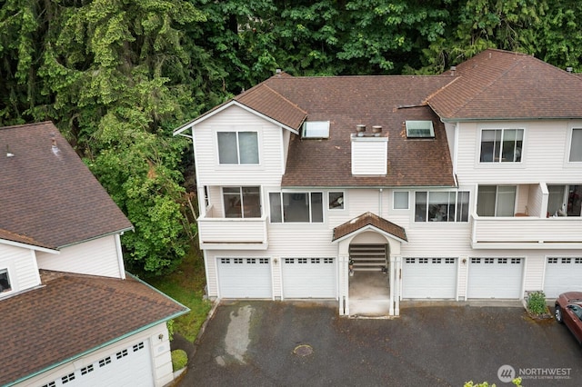 8828 238th St SW Unit D-1, Edmonds, WA 98026 - view of front facade with asphalt driveway, roof with shingles, and a garage
