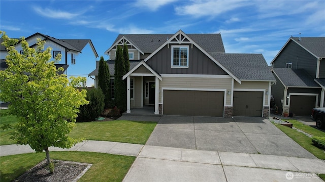 10027 SE Dotson St SE, Yelm, WA 98597 - craftsman-style home featuring board and batten siding, stone siding, concrete driveway, a front yard, and an attached garage