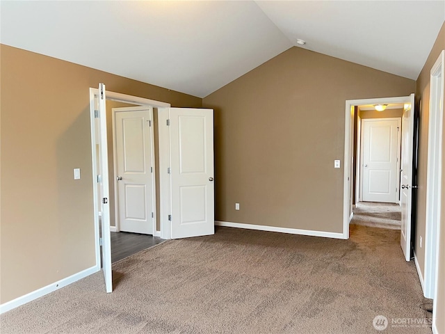 10027 SE Dotson St SE, Yelm, WA 98597 - unfurnished bedroom with carpet flooring, vaulted ceiling, and baseboards