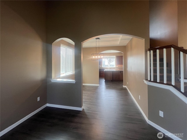 10027 SE Dotson St SE, Yelm, WA 98597 - corridor featuring dark wood-type flooring, baseboards, and a chandelier