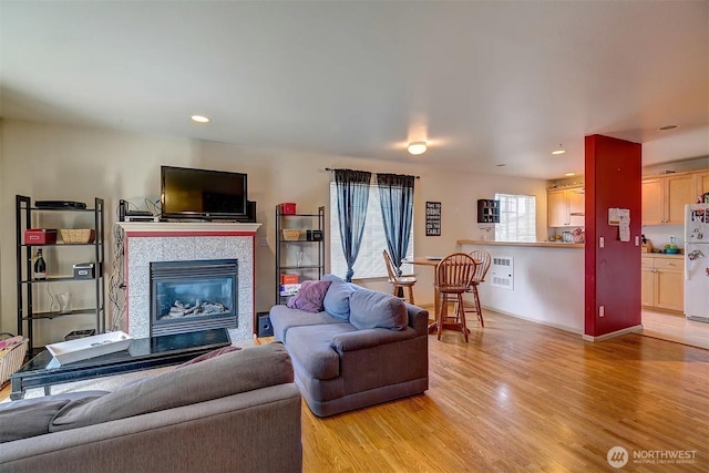 536ST N 103rd Unit A, Seattle, WA 98133 - living area featuring light wood-style flooring, a tiled fireplace, and recessed lighting