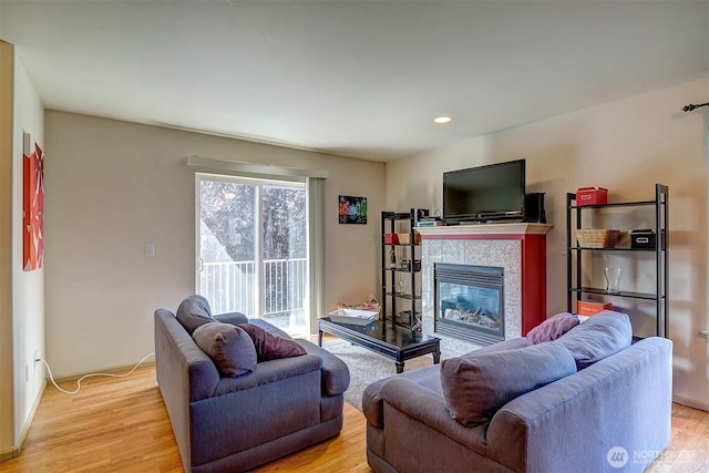 536ST N 103rd Unit A, Seattle, WA 98133 - living room featuring light wood-style floors, a tiled fireplace, and recessed lighting