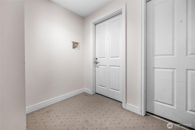 4343 Roosevelt Way NE Unit 401, Seattle, WA 98105 - doorway to outside featuring baseboards and light colored carpet