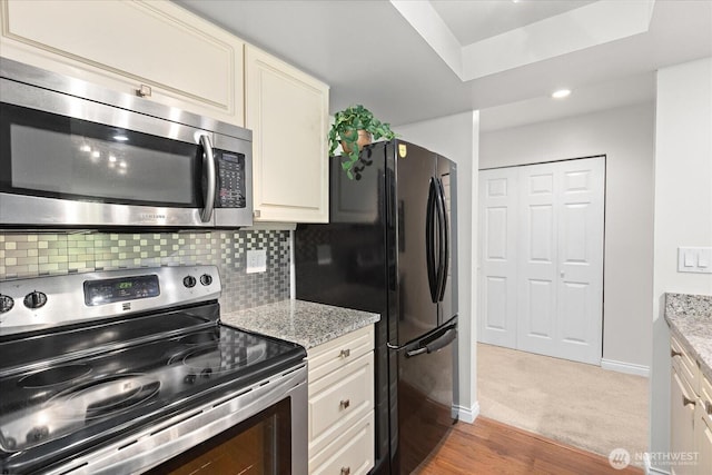 15512 Country Club Dr Unit B25, Mill Creek, WA 98012 - kitchen with stainless steel appliances, baseboards, backsplash, and light stone counters