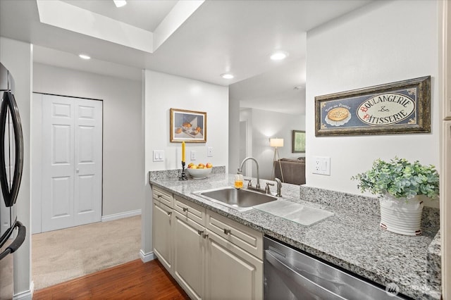 15512 Country Club Dr Unit B25, Mill Creek, WA 98012 - kitchen with stainless steel dishwasher, a sink, freestanding refrigerator, baseboards, and dark wood-style flooring