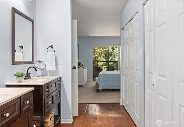 15512 Country Club Dr Unit B25, Mill Creek, WA 98012 - bathroom with two vanities, wood finished floors, a closet, and baseboards