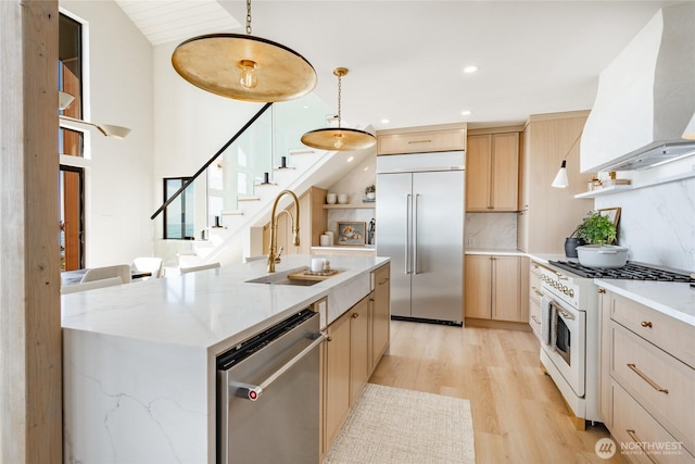 4489 Sucia Dr, Ferndale, WA 98248 - kitchen with appliances with stainless steel finishes, custom range hood, light brown cabinets, light wood-style floors, and recessed lighting