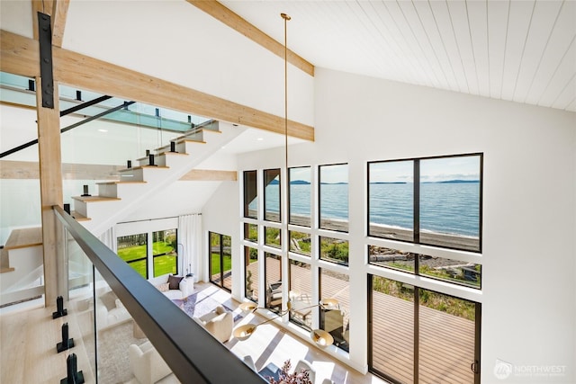 4489 Sucia Dr, Ferndale, WA 98248 - staircase with high vaulted ceiling, a water view, beam ceiling, and wood finished floors