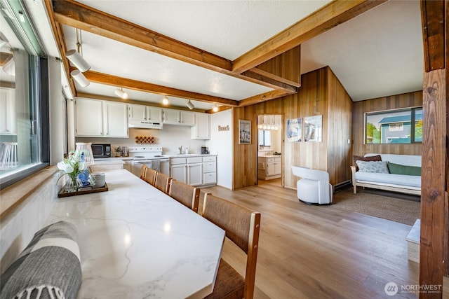 4489 Sucia Dr, Ferndale, WA 98248 - dining area with light wood finished floors, beam ceiling, and wooden walls