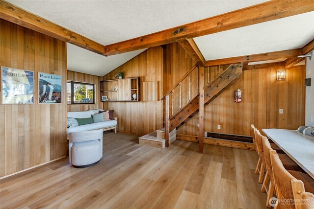 4489 Sucia Dr, Ferndale, WA 98248 - living room featuring wooden walls, light wood-style flooring, and stairway