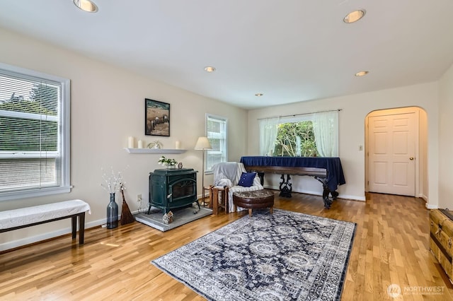 12019B 25th Ave NE, Seattle, WA 98125 - living area with a wood stove, light wood finished floors, recessed lighting, and baseboards